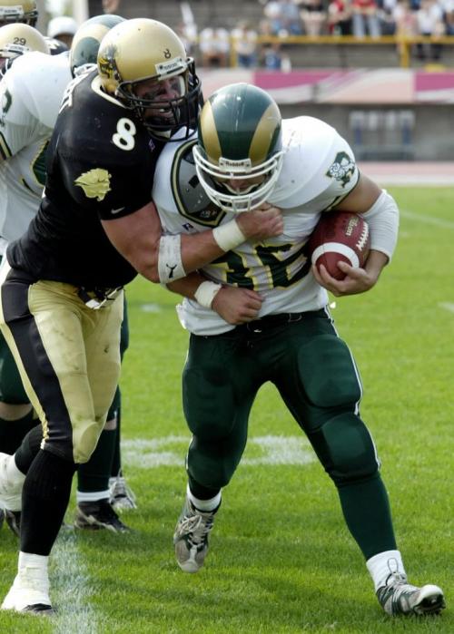 Regina Rams' running back Neil Hughes is tackled by Bison middle line backer Scott Gilbert during the Saturday afternoon game at the University of Manitoba.  Gillian Waechter/ Winnipeg Free Press